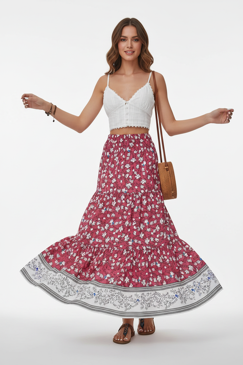Jupe longue bohème Silhouette-Chic à imprimé floral avec volants étagés et bordure contrastée - mannequin en mouvement de rotation tournoyant sur fond blanc studio, capturant le mouvement spectaculaire des trois étages de volants qui s'évasent, l'effet romantique et aérien de la jupe en mouvement et la beauté de l'imprimé floral qui danse